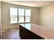 Bright kitchen featuring quartz countertop island, wood floors, and a large window view at 15106 Grove Lake Dr, Winter Garden, FL 34787