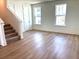 Spacious living room with hardwood flooring, staircase, and abundant natural light at 15106 Grove Lake Dr, Winter Garden, FL 34787