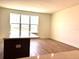 Bright, open living room featuring hardwood floors and large window with a neighborhood view at 15106 Grove Lake Dr, Winter Garden, FL 34787