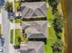 Aerial view of residential properties with well-maintained lawns, driveways, and mature trees at 1546 Water Elm Ct, Orlando, FL 32825