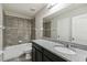 Bathroom featuring a shower-tub combo with tiled surround and a granite countertop vanity at 1546 Water Elm Ct, Orlando, FL 32825
