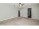 Neutral bedroom with carpeted floors, offering access to a closet and the bathroom at 1546 Water Elm Ct, Orlando, FL 32825