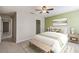Inviting bedroom with a decorative green wall, soft rug, and stylish modern furnishings at 1546 Water Elm Ct, Orlando, FL 32825