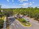 Aerial view of the community entrance with a guard house and an American flag at 1546 Water Elm Ct, Orlando, FL 32825