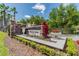 Stone community sign with lush landscaping including flowers and manicured shrubs at 1546 Water Elm Ct, Orlando, FL 32825