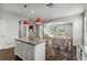 Open-concept kitchen with a granite island, stainless steel appliances, and hardwood floors adjacent to dining area at 1546 Water Elm Ct, Orlando, FL 32825