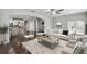 Bright living room with hardwood floors, neutral-toned furniture, and an open layout to the kitchen at 1546 Water Elm Ct, Orlando, FL 32825