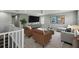 Upstairs living room features modern decor, a large TV, and two comfy brown chairs at 1546 Water Elm Ct, Orlando, FL 32825