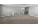 Neutral toned loft space with carpet flooring and a white railing at 1546 Water Elm Ct, Orlando, FL 32825