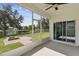 Enclosed patio featuring an outdoor fire pit and views of the backyard overlooking a tranquil pond at 1546 Water Elm Ct, Orlando, FL 32825