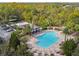Aerial view of a community pool, lounge chairs, and a covered pavilion at 1546 Water Elm Ct, Orlando, FL 32825