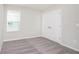 Bright bedroom with a large window and double closet doors for ample storage space at 3987 Sagefield Dr, Harmony, FL 34773