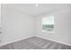 Bright bedroom with a large window and neutral carpet, perfect for relaxation at 3987 Sagefield Dr, Harmony, FL 34773