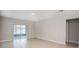 Spacious living room with large sliding doors offering scenic views of the outdoors at 3987 Sagefield Dr, Harmony, FL 34773