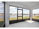 Enclosed patio with stunning views of the lake and lush greenery, perfect for relaxing at 3987 Sagefield Dr, Harmony, FL 34773