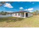 Exterior home backyard featuring a covered patio and manicured lawn at 8908 Sw 133Rd Ln, Ocala, FL 34473
