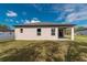 Back exterior with covered patio and manicured lawn at 8908 Sw 133Rd Ln, Ocala, FL 34473