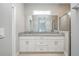 Bathroom showcasing a double vanity with granite counters and a glass-enclosed shower at 8908 Sw 133Rd Ln, Ocala, FL 34473