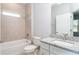 Bright bathroom featuring a tub with tiled walls, white toilet, and granite countertop vanity at 8908 Sw 133Rd Ln, Ocala, FL 34473