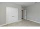 Neutral bedroom features a closet and connecting bathroom door at 8908 Sw 133Rd Ln, Ocala, FL 34473