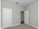 Neutral bedroom featuring two white doors and neutral colored carpet at 8908 Sw 133Rd Ln, Ocala, FL 34473