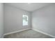 Neutral bedroom with one window and plush carpeting offers tranquility at 8908 Sw 133Rd Ln, Ocala, FL 34473
