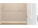 Empty walk-in closet showing the interior with a door slightly ajar and carpeted floor at 8908 Sw 133Rd Ln, Ocala, FL 34473