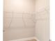 Empty walk-in closet with wire shelving and neutral walls on a carpeted floor at 8908 Sw 133Rd Ln, Ocala, FL 34473