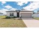 Inviting single-story home featuring a neutral color scheme, attached two-car garage, and well-maintained landscaping at 8908 Sw 133Rd Ln, Ocala, FL 34473