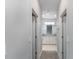 Hallway view leading to a bathroom with double vanity, granite countertops, and tiled floors at 8908 Sw 133Rd Ln, Ocala, FL 34473