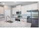 Modern kitchen featuring granite countertops, stainless appliances, and sleek cabinets at 8908 Sw 133Rd Ln, Ocala, FL 34473