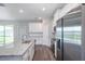 Modern kitchen with white cabinets, granite countertops, stainless steel appliances, and wood flooring at 8908 Sw 133Rd Ln, Ocala, FL 34473
