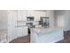 Kitchen with stainless steel appliances, white cabinets, granite countertops, and central island at 8908 Sw 133Rd Ln, Ocala, FL 34473