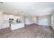 Bright open space with kitchen island, white cabinets, stainless appliances, and durable wood flooring at 8908 Sw 133Rd Ln, Ocala, FL 34473