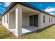 Outdoor covered patio overlooking the lawn and blue sky at 8908 Sw 133Rd Ln, Ocala, FL 34473