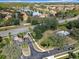 Community aerial view with a scenic lake, pool, mature landscaping, and well-maintained roadways at 2911 Sunset Vista Ct, Kissimmee, FL 34747