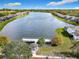 Aerial shot of the community showing a tranquil lake with a dock and gazebo surrounded by beautifully maintained homes at 2911 Sunset Vista Ct, Kissimmee, FL 34747