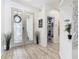 Bright foyer with wood-look floors, glass doors, stylish decor, and a peek into a well-organized storage area at 2911 Sunset Vista Ct, Kissimmee, FL 34747