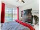 Serene main bedroom with pool view through sliding glass doors, complemented by stylish decor and a wooden dresser at 2911 Sunset Vista Ct, Kissimmee, FL 34747