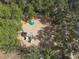 Overhead view of the community playground featuring play equipment under a canopy of mature trees at 2911 Sunset Vista Ct, Kissimmee, FL 34747