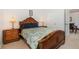 Bedroom with wooden bed frame and access to a nearby dining area at 8169 Fan Palm Way, Kissimmee, FL 34747