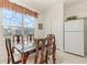 Charming breakfast nook with a wooden table and four chairs, near kitchen at 8169 Fan Palm Way, Kissimmee, FL 34747