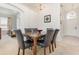 Formal dining area featuring a marble-top table and six chairs, near entryway at 8169 Fan Palm Way, Kissimmee, FL 34747