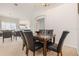 Elegant dining room with a marble table and six black leather chairs at 8169 Fan Palm Way, Kissimmee, FL 34747