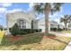 One-story house with a two-car garage and lush landscaping at 8169 Fan Palm Way, Kissimmee, FL 34747