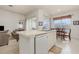 Kitchen with island, white cabinets, and a view into the breakfast area at 8169 Fan Palm Way, Kissimmee, FL 34747