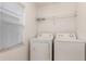 Laundry room with washer, dryer, and overhead shelving at 8169 Fan Palm Way, Kissimmee, FL 34747