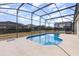 Enclosed rectangular pool with a concrete deck at 8169 Fan Palm Way, Kissimmee, FL 34747