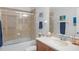 Bathroom boasting a shower-tub combo, a framed mirror, and tile at 207 Maplebrook Dr, Altamonte Springs, FL 32714