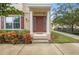 Inviting house entrance with brown door, columns, and landscaping at 207 Maplebrook Dr, Altamonte Springs, FL 32714